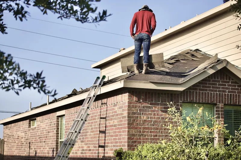 Professional roofer working on a residential roof in Driscoll